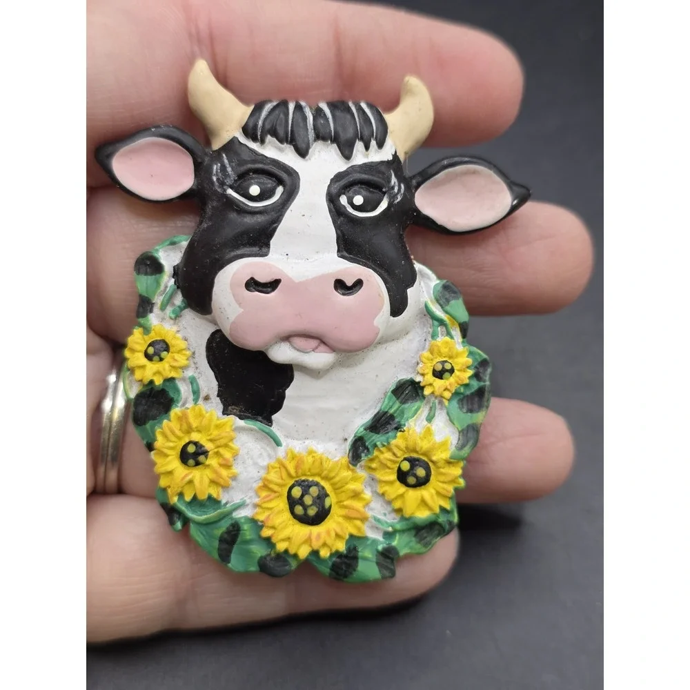This collection features various vintage-style cow refrigerator magnets